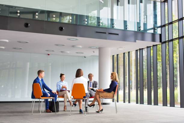 istock Business colleagues planning strategy while sitting on chairs during meeting 1192040370