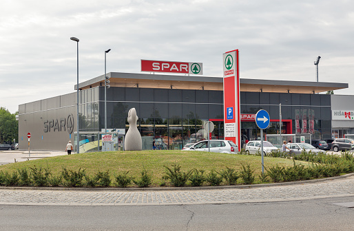 LENDAVA, SLOVENIA - JULY 09, 2019: People visit Spar supermarket. It is a Dutch multinational retail chain, operates as independent or franchise in 35 countries worldwide.