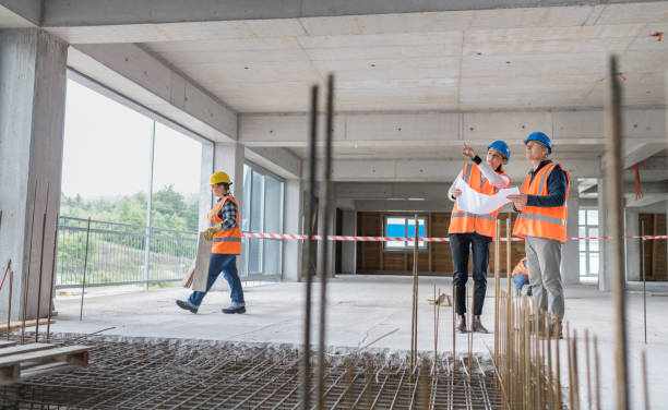 istock Foreman and forewoman discussing blueprint 1192041857