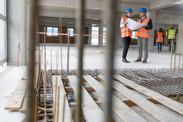 istock Foreman and forewoman discussing blueprint 1192041872