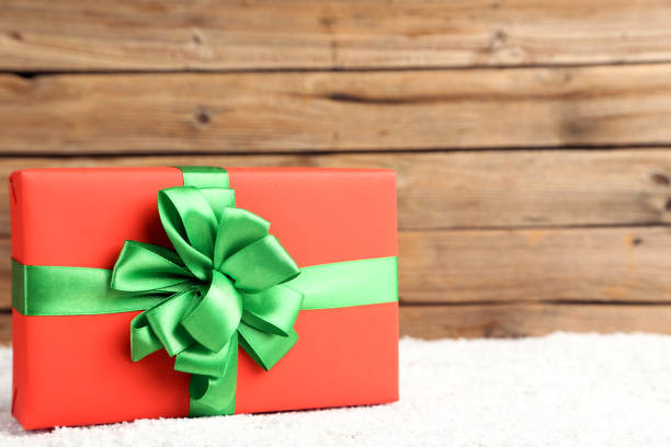 istock Gift box with ribbon on brown wooden background 1192042794