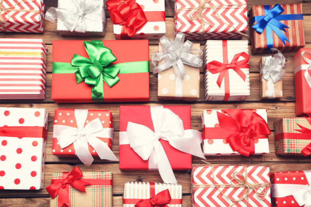 istock Gift boxes with ribbons on brown wooden table 1192044684