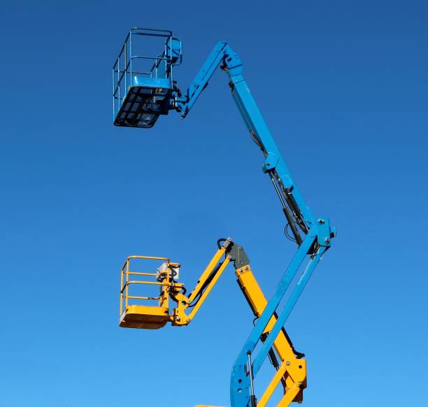 istock Two aerial work platforms, one over the other, against cloudless blue sky 1192044810