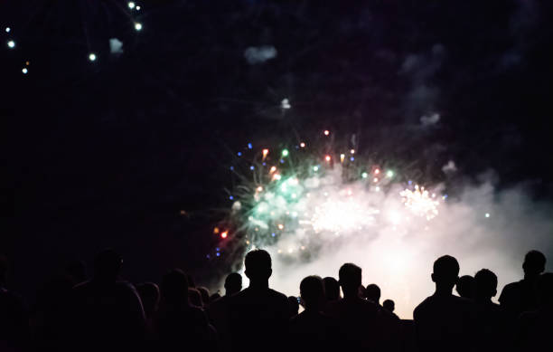 istock Crowd watching fireworks and celebrating new year eve 1192046657