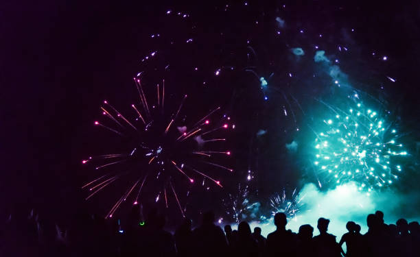 istock New year concept - cheering crowd and fireworks 1192046725