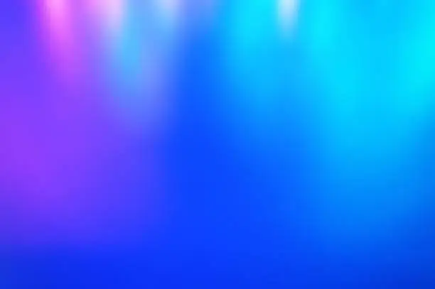 Photo of Blurred multicolored and classic blue  color background from light. Iridescent holographic abstract bright neon colors backdrop.