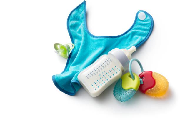 istock Baby Goods: Baby Bottle, Teething Ring, Bib and Pacifier Isolated on White Background 1192050745