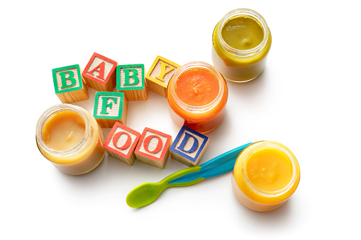Baby Goods: Baby Food, Baby Spoon and Alphabet Blocks Isolated on White Background