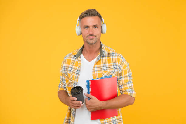 istock Never too late to study. Educational technology. Study again. Audio book concept. Worldwide knowledge access. Audio library. Another way of study. Man handsome college student headphones books 1192052069