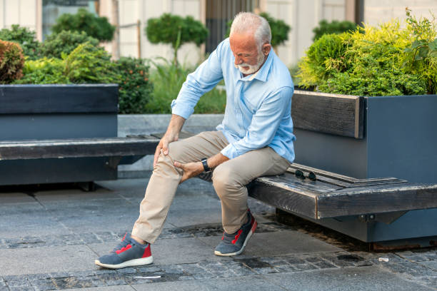 istock Senior Businessman with Knee Problems in the City Streets 1192054103