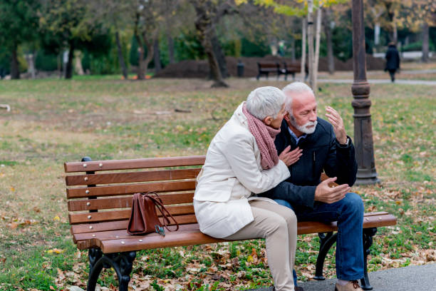 istock Depressed Senior Man Consoled By Elderly Woman 1192054389