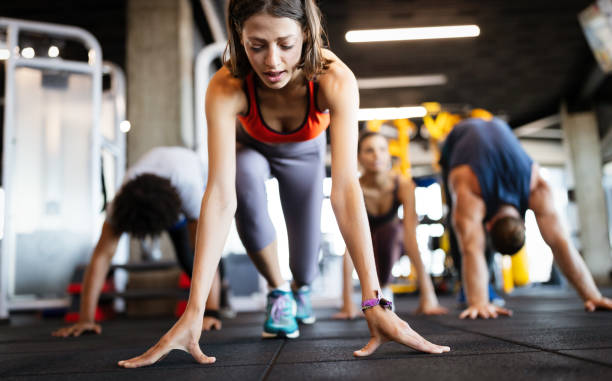 istock Healthy young athletes friends doing exercises at gym. 1192054480