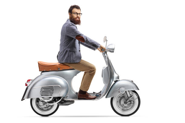 istock Bearded man riding a vintage scooter 1192055523