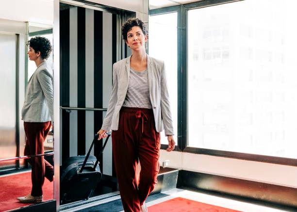istock Female entrepreneur exiting elevator in hotel 1192055772