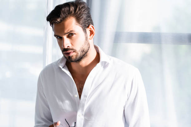 istock Handsome businessman in shirt looking at camera 1192055991