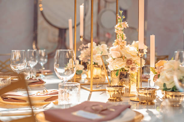 istock Gold color floral decorations on a wedding table 1192056197