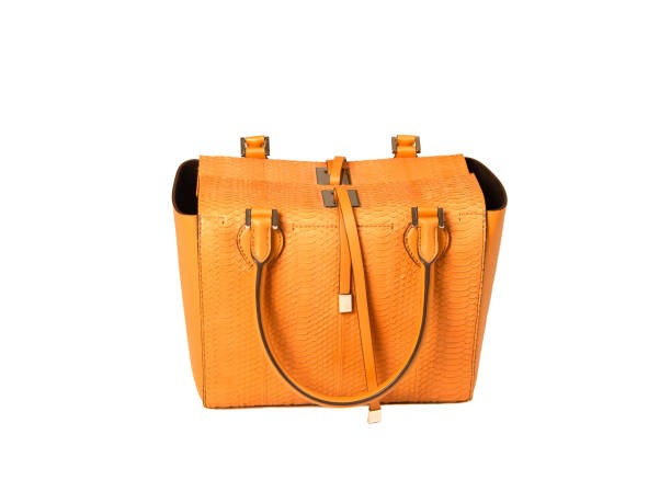 istock Yellow women bag made of python skin on a white background 1192058376