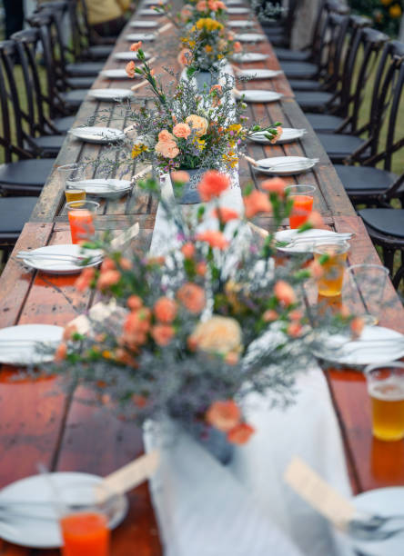 istock Rustic wedding style, Wooden dining table with flowers decoration and tableware 1192060356