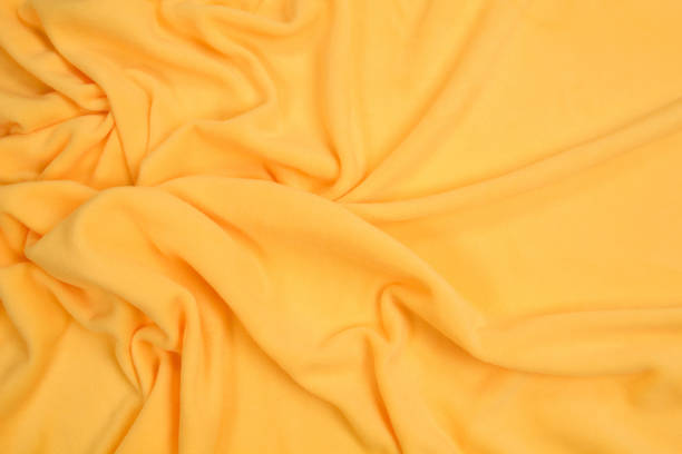 istock Fleece fabric yellow top view. Texture of textile fleece bedspread. 1192061130