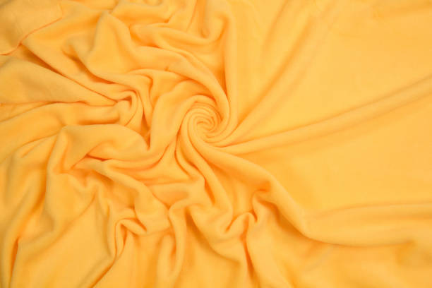 istock Fleece fabric yellow top view. Texture of textile fleece bedspread. 1192061151