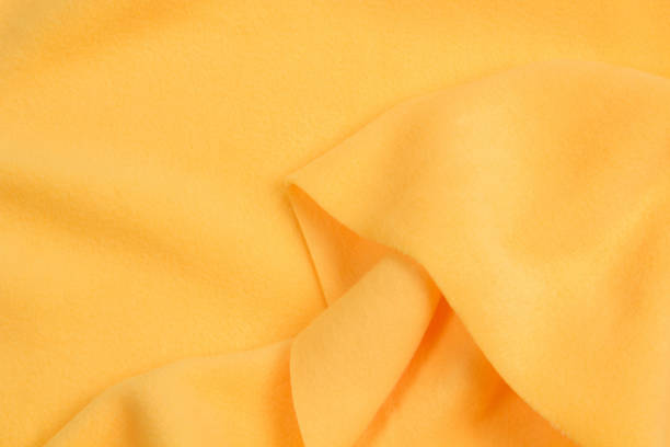 istock Fleece fabric yellow top view. Texture of textile fleece bedspread. 1192061155