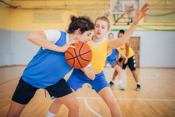 istock Four women playing basketball indoors 1192061699