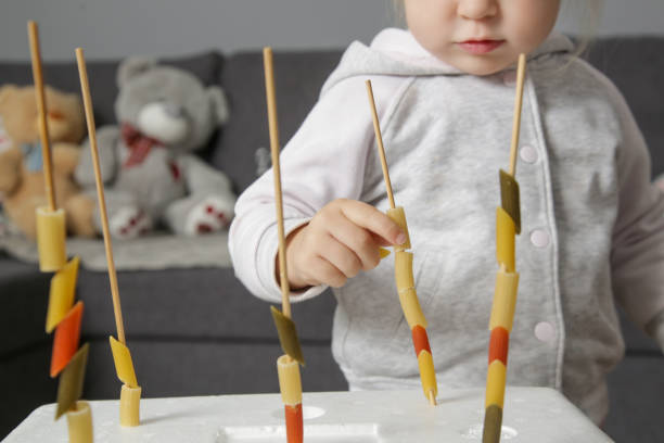 istock Fine motor pasta threading activity for kids. An easy and fun tower building challenge that works on fine motor skills as well as hand eye coordination. 1192063348