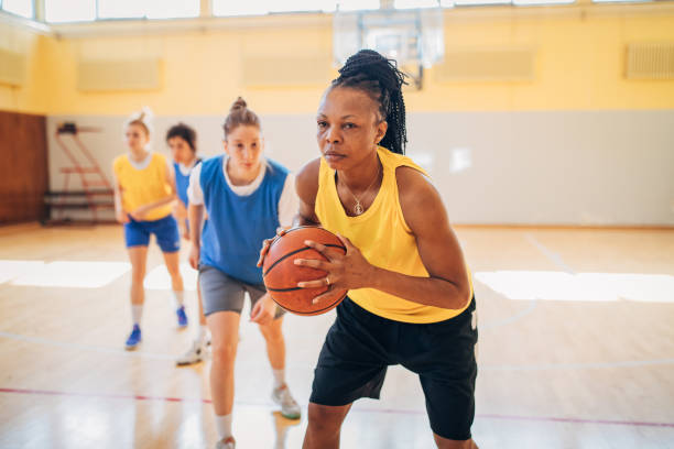 istock Women playing basketball indoors 1192063419