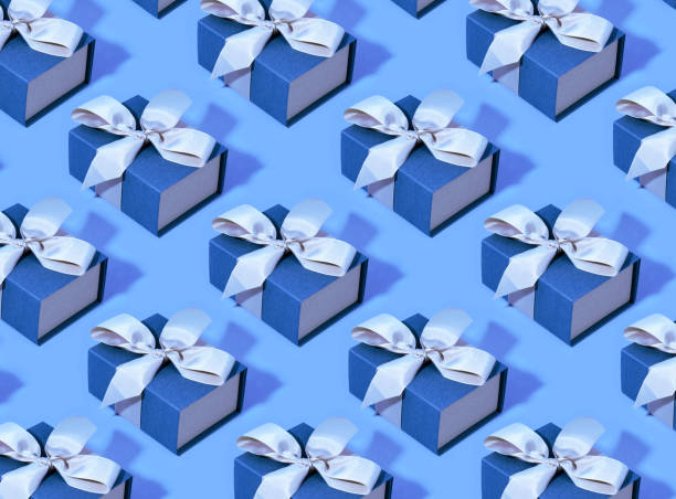 istock Pattern made of blue gift boxes on pastel background. Trendy color 1192064565