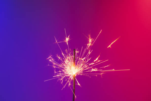 istock A burning sparkler in bright neon background. 1192067278