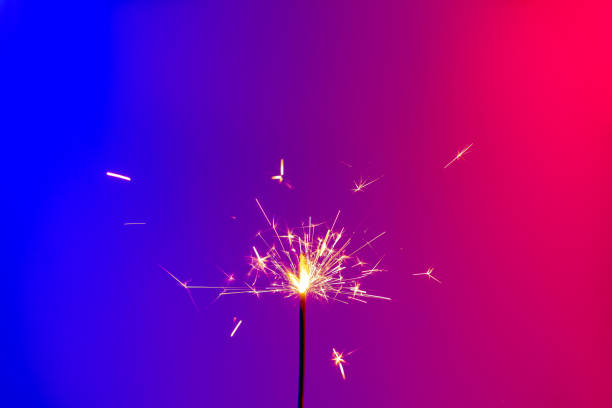 istock A burning sparkler in bright neon background. 1192067301