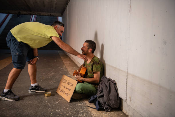 istock Man is Helping Beggar in the Street 1192067333