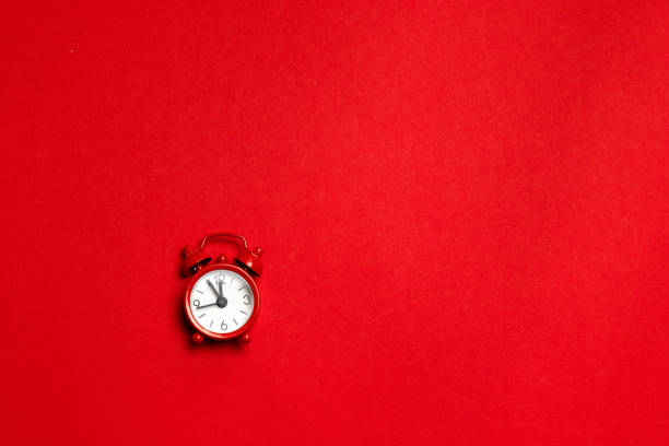 istock Red alarm clock in a minimal style on a red background. Flat lay. Holiday concept 1192067695