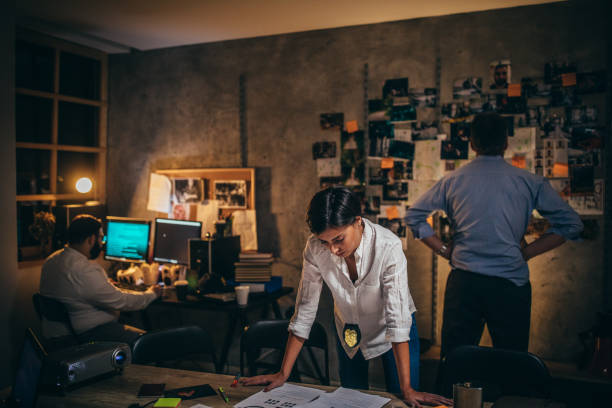 istock Lady detective working on a case with colleagues 1192068664