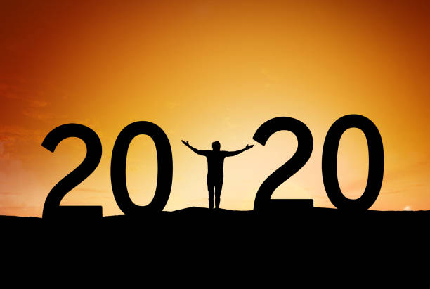 istock 2020, silhouette of a successful man standing at hill raising hands 1192068714