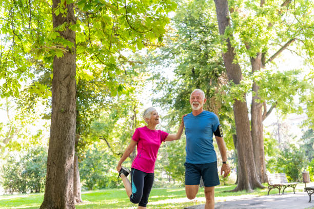 istock Active Senior Couple is Stretching Outdoors in Nature 1192069136