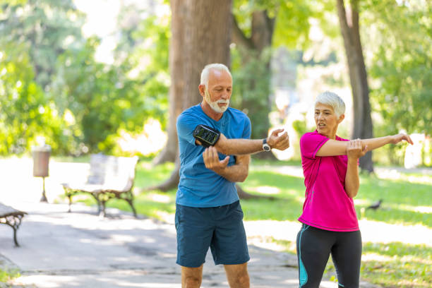 istock Active Senior Couple is Stretching Outdoors in Nature 1192069921
