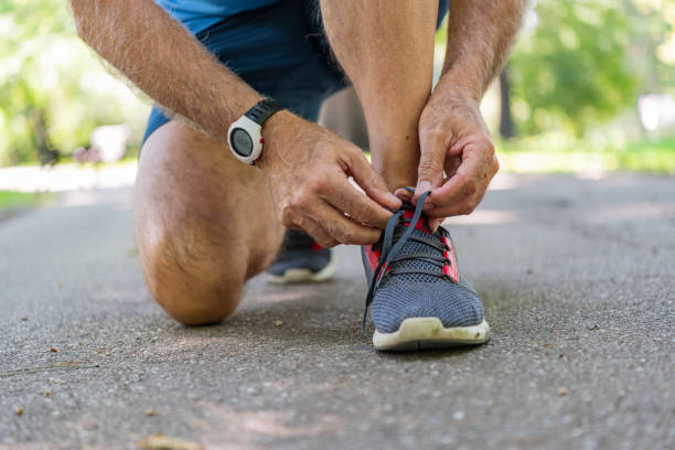 istock Senior Athlete Tying Sneaker Shoe 1192070415