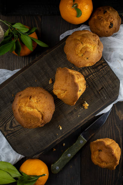 istock Tangerine cupcakes with chocolate chips on an old dark wooden Board 1192071311