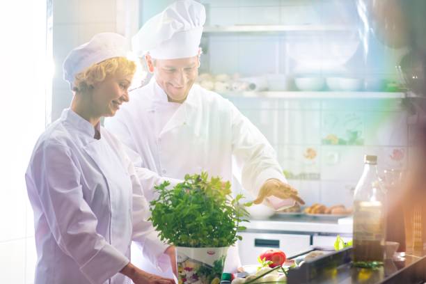 istock Mature chefs preparing and cooking together in kitchen restaurant 1192071948