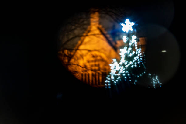 2019 Christmas tree in the grounds of the Houses of Parliament and beside Westminster Abbey. It is shot through a lens mask (pinhole camera) to create a spooky blurred look.