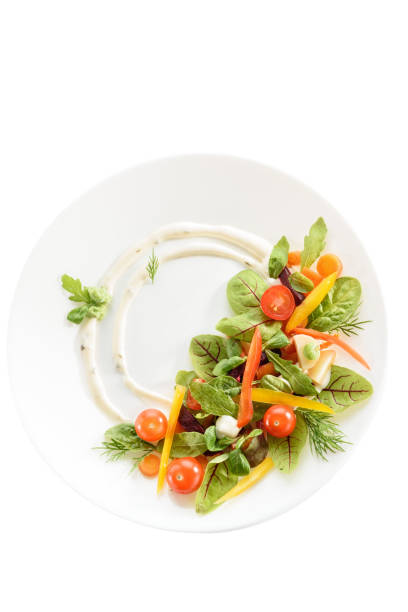 istock micro-greens and vegetables salad on a white plate 1192074539