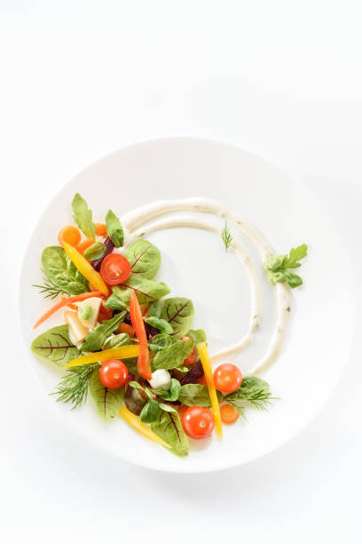 istock micro-greens and vegetables salad on a white plate 1192074624