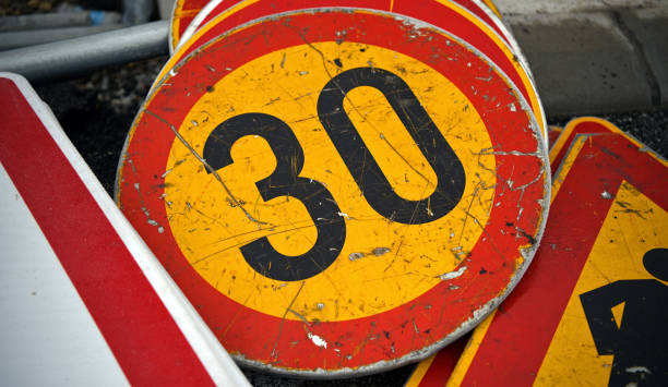 istock Speed limit sign. Yellow-red speed limit signage. Number 30 1192074983