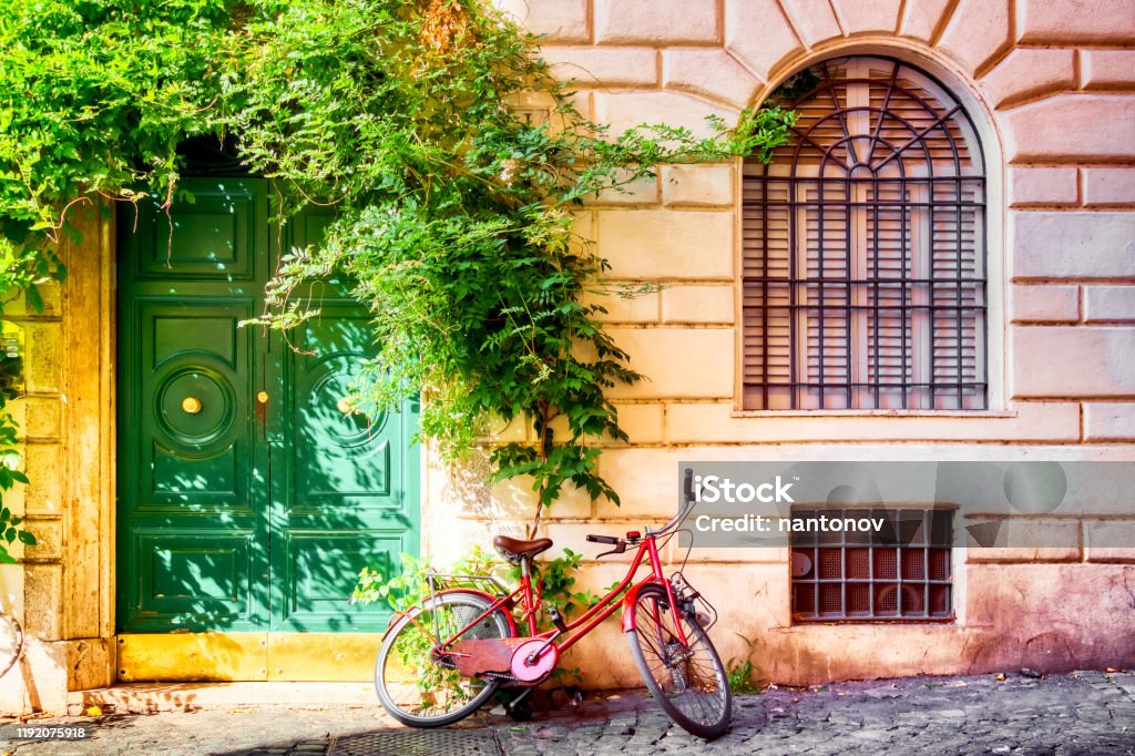 Old House Wall In Trastevere Rome Italy With A Red Bicycle And Green Door  Old Cozy Street In Rome Stock Photo - Download Image Now - iStock