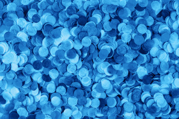 Festive blue confetti background. Flat lay style.