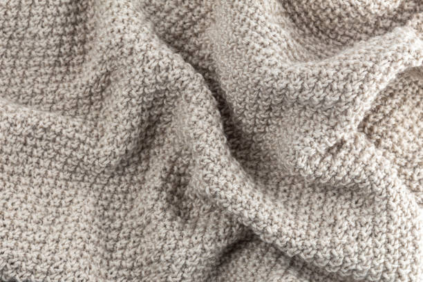 istock Textured background from wool yarn. Crumpled warm beige plaid 1192077278