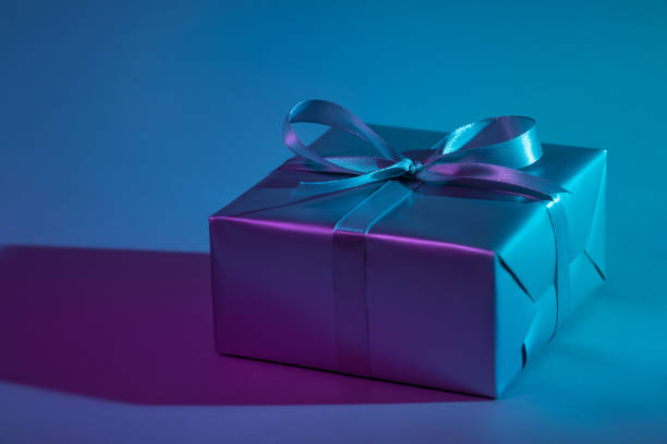 istock Gift box illuminated with colorful lights 1192077449