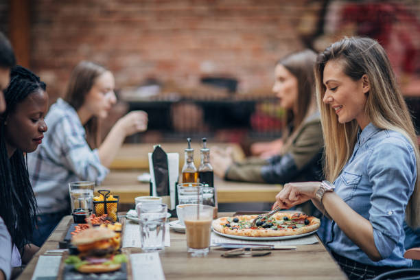 istock Beautiful women sitting outdoors in restaurant 1192078770