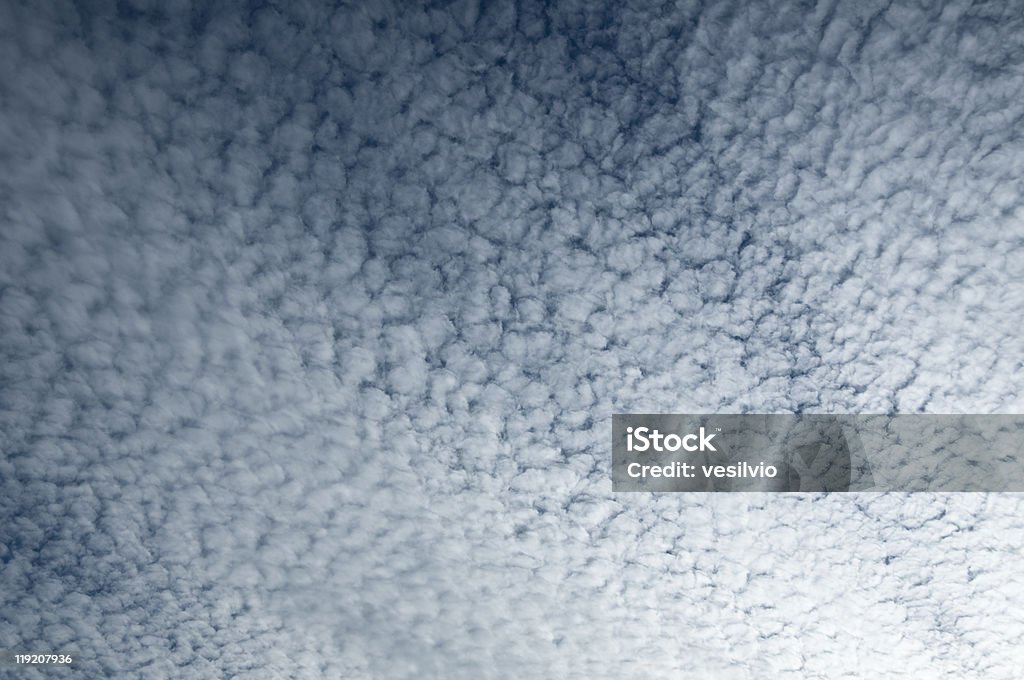 Scattered clouds Scattered cirrocumulus clouds during a late summer afternoon. Useful as background. Backgrounds Stock Photo